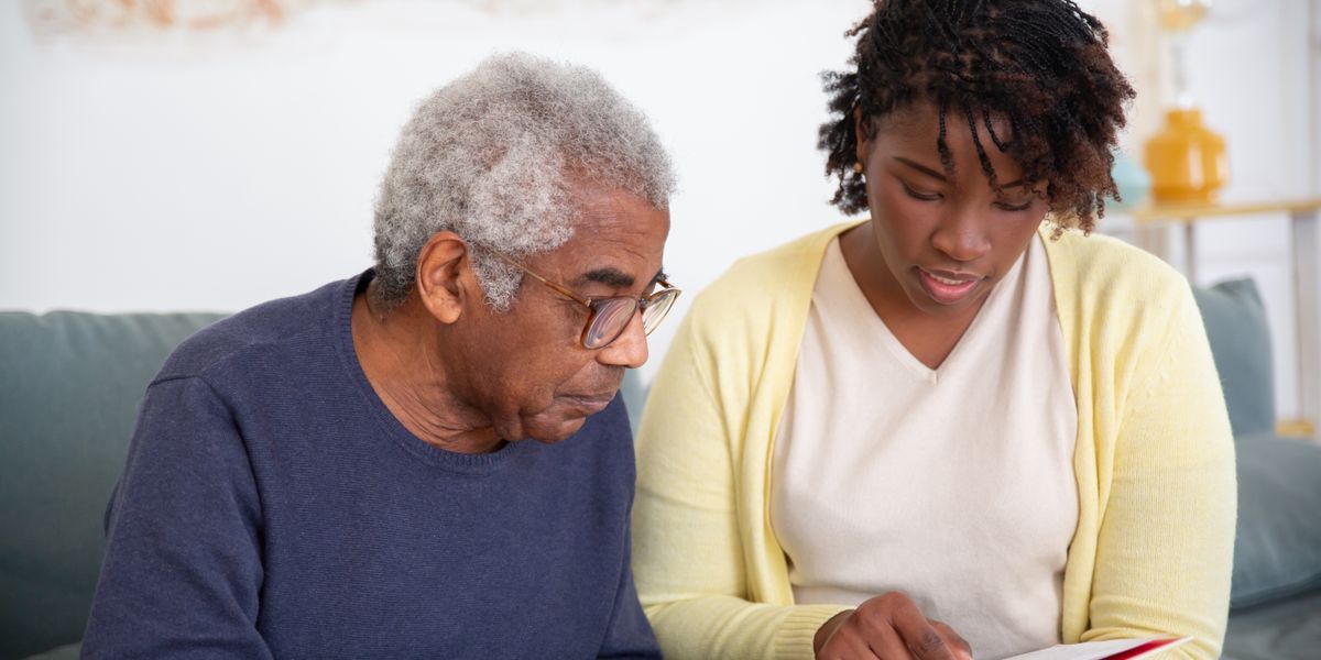 A caregiver helping a senior man